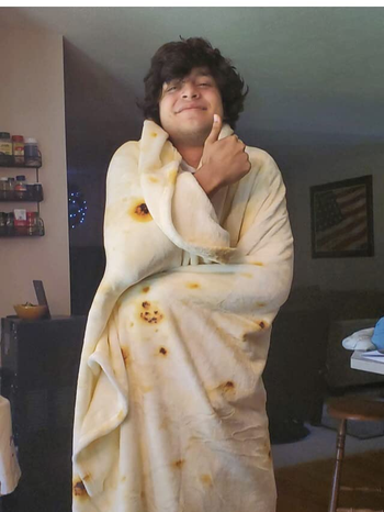 a reviewer wrapped in a blanket that looks like a tortilla 