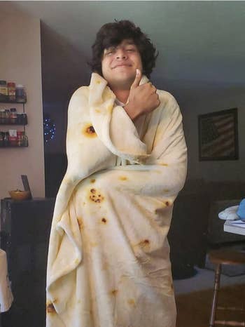a reviewer wrapped in a blanket that looks like a tortilla 