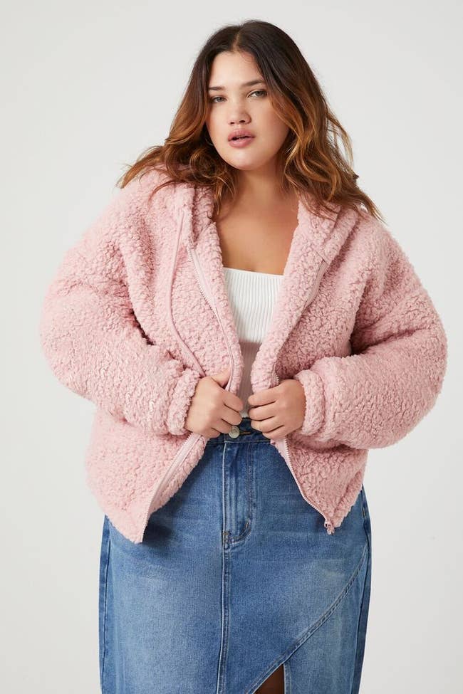 model wearing pink faux shearling jacket