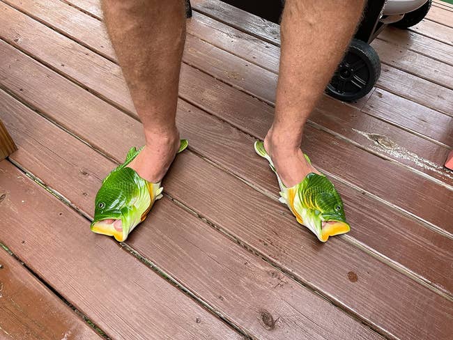 close up image of the green fish sandals on a reviewer's feet