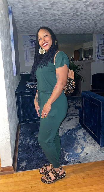 Different reviewer wearing the jumpsuit in dark green