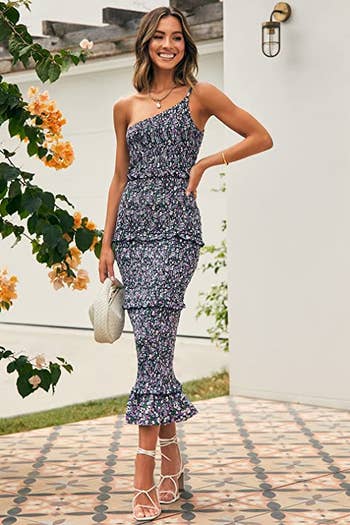 A full view of model wearing navy blue floral dress