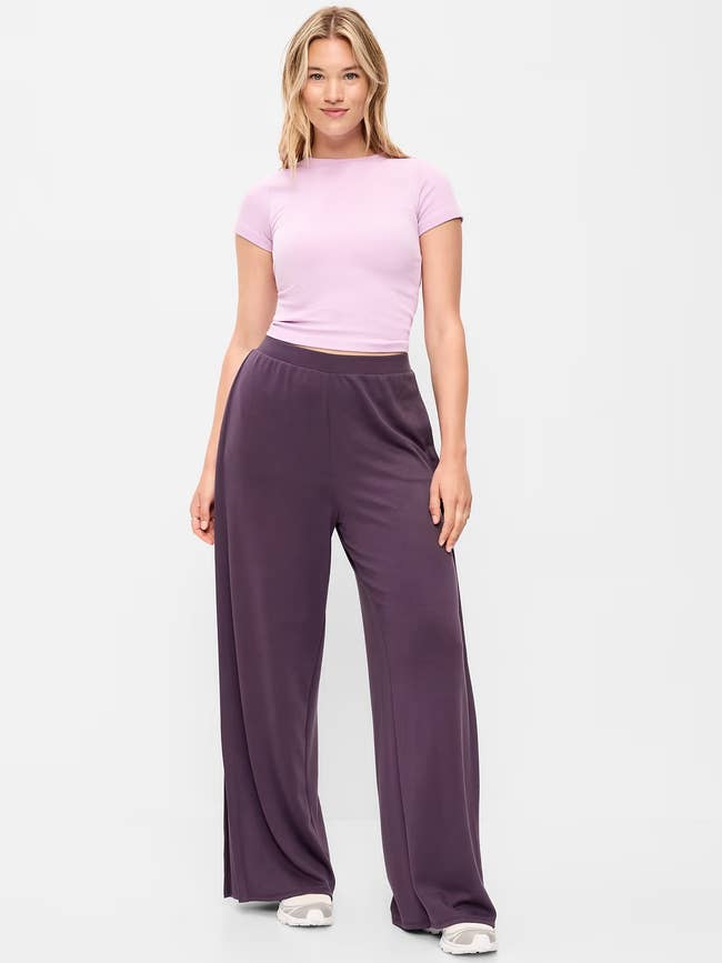 Person wearing a fitted short-sleeve apical  and wide-leg pants, lasting  confidently. Ideal casual outfit for comfortableness  and style