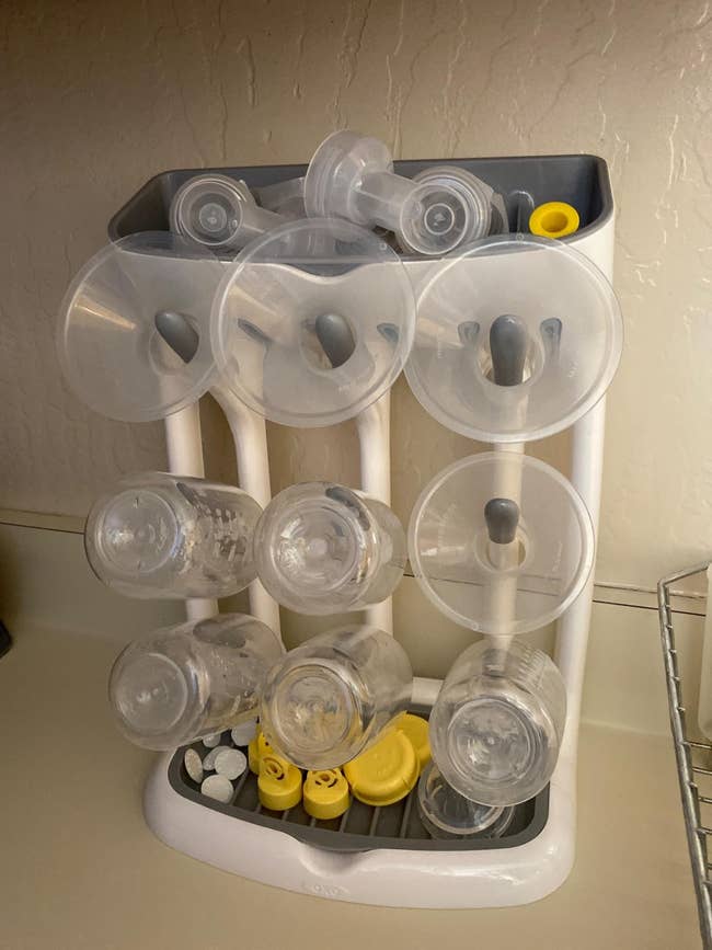 reviewer image of the vertical drying rack filled with baby bottle products