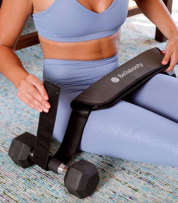 model showing how you attach dumbbells to the belt