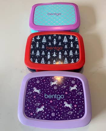 reviewer photo of three lunchboxes in different prints