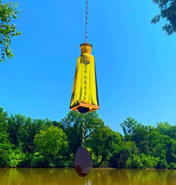 close up of the yellow wind chime against the sky