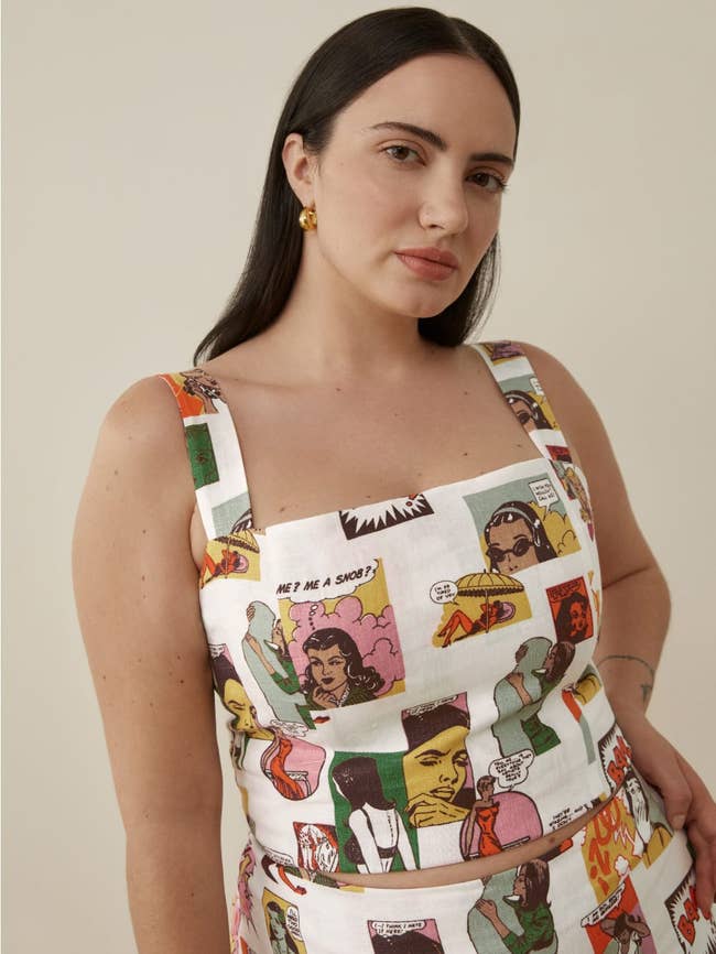 model wearing the white square-neck linen top with illustration of women comic strips all over it