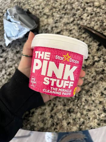 reviewer holding the pink stuff in their hands