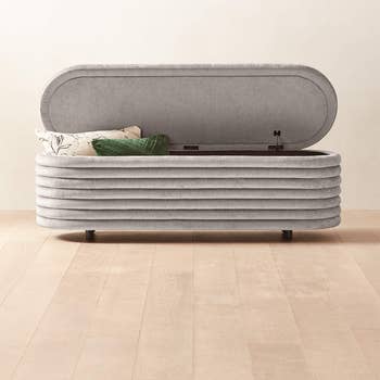 product image of the bench in gray, lift top open