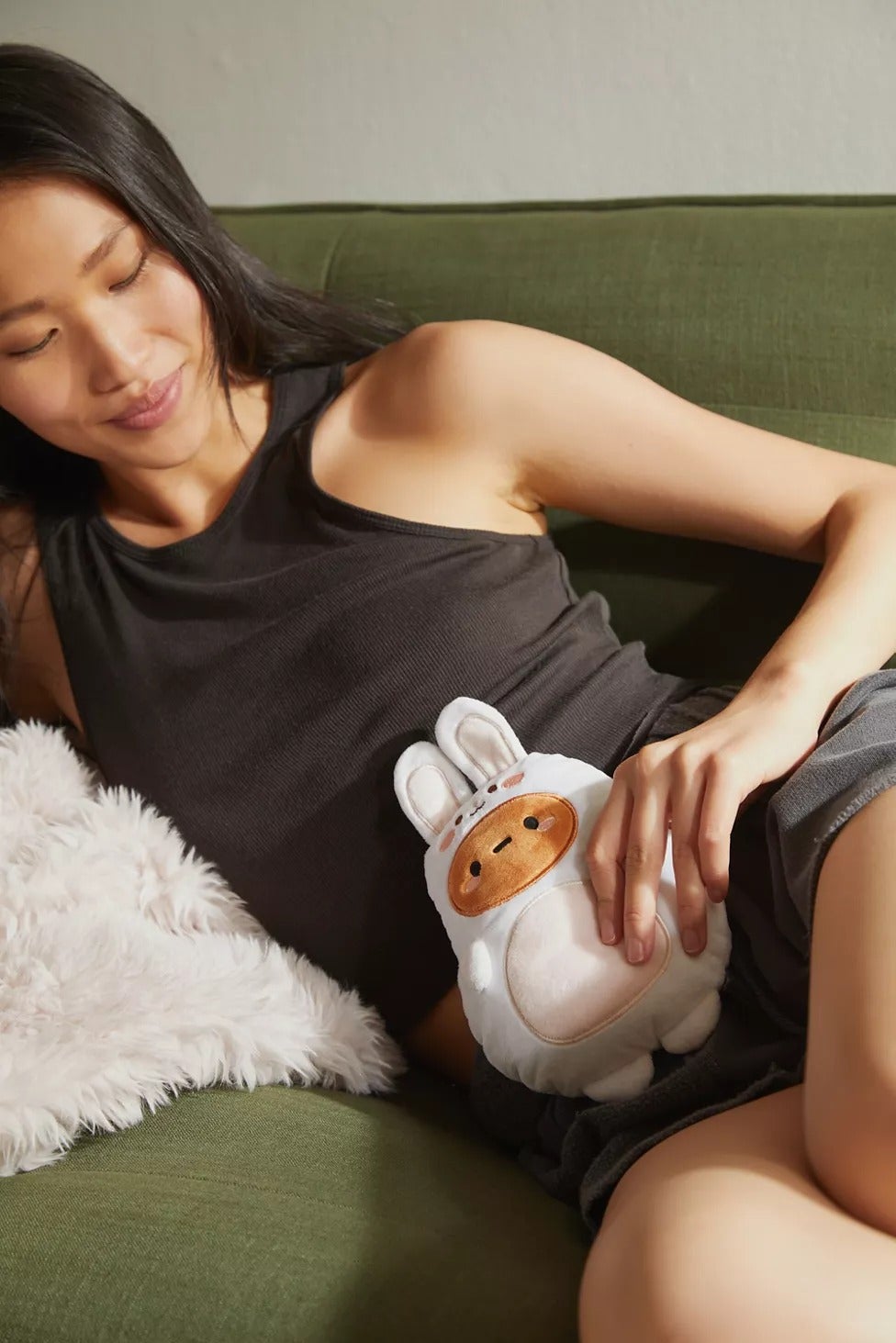 model holding plush potato in bunny suit up to their body