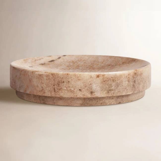 Marble bowl with a smooth, polished surface and a wide, shallow design, suitable for decorative or functional home use as mentioned in a shopping article