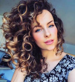 A reviewer with large, defined curls