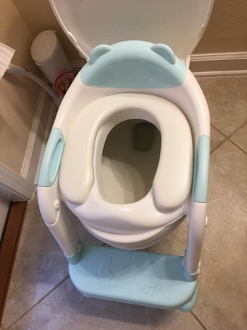 reviewer image of the blue step stool next to a toilet
