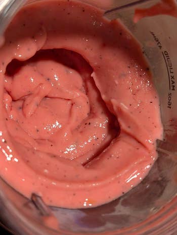 Close-up of a creamy, fruity smoothie substance successful a blender, highlighting its texture and caller ingredients. Ideal for a steadfast manner piece
