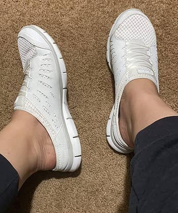 Reviewer wearing white sneakers