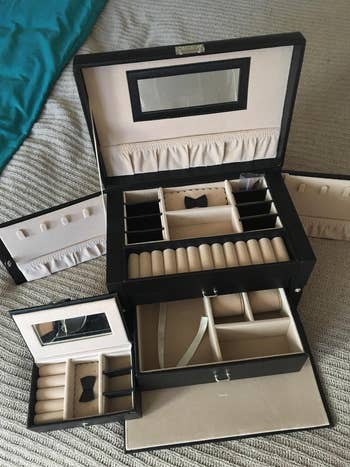 reviewer photo of the black jewelry boxes, showing all the compartments