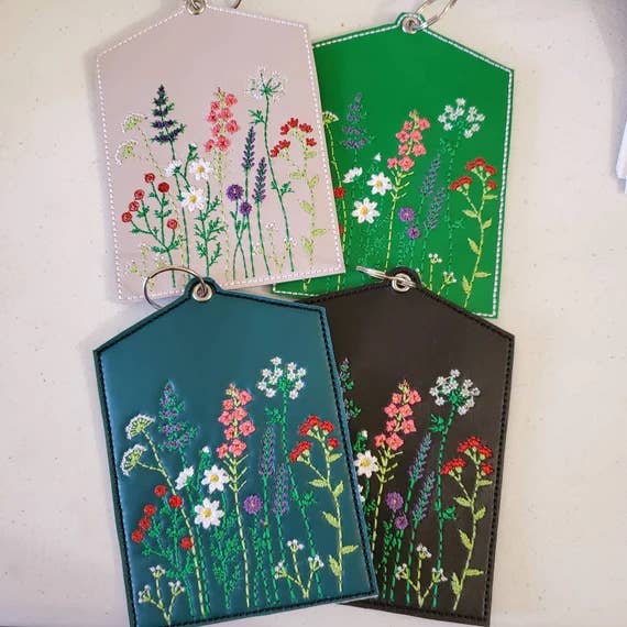 four floral embroidered vaccine card holders