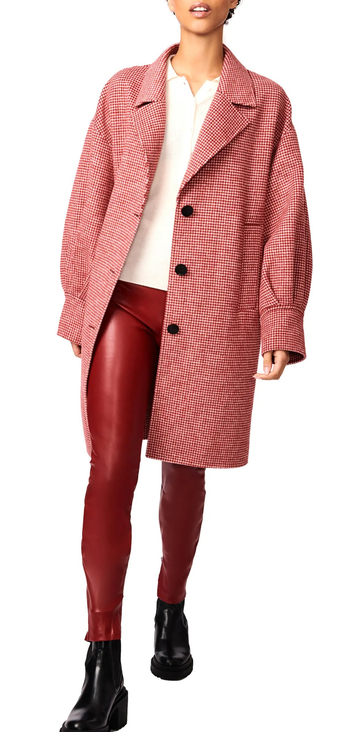 A model wearing the houndstooth coat unzipped