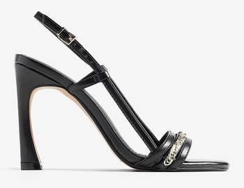 black sandals with very high sculptural heel and silver embellishment