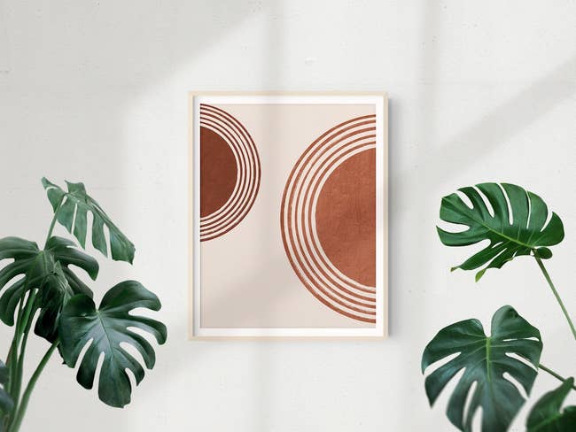 Abstract art piece with geometric shapes framed on a wall