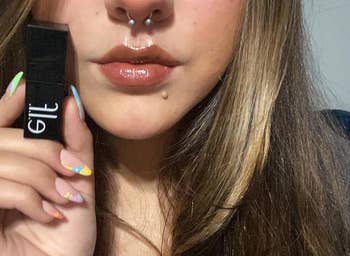 reviewer holding and wearing the cinnamon dreamz shade