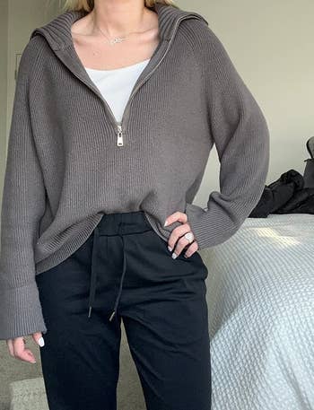 a reviewer wearing the sweater. in gray 