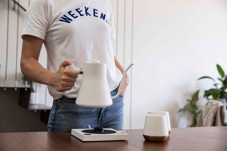 model holding the white kettle