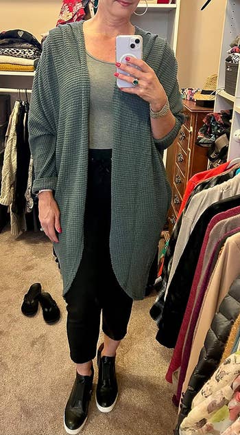 a reviewer wearing the cardigan in dark blue 