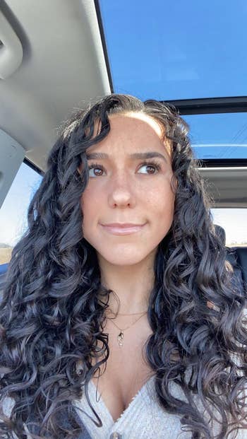 reviewer selfie showing off curly hair after using product