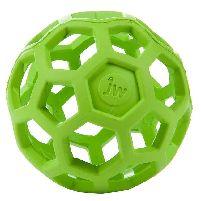 the round green toy with holes in it