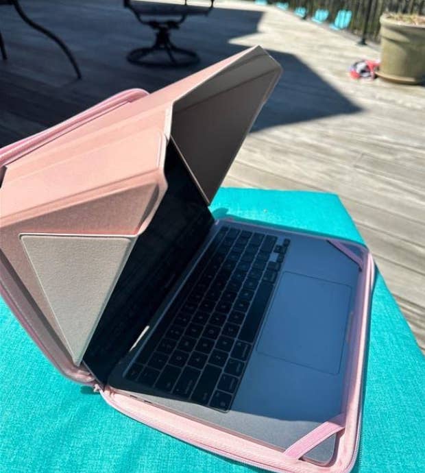 reviewer's computer with shade covering screen. placed outside on deck.