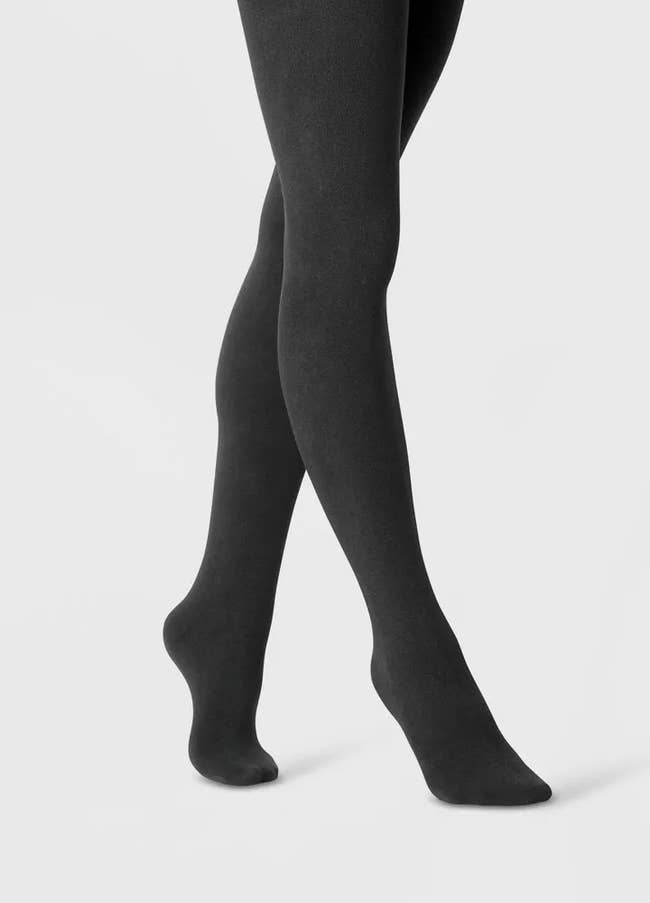 model wearing black footed tights