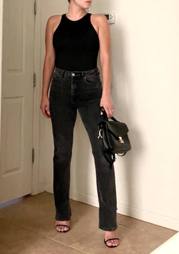 a reviewer wearing the bodysuit with jeans and heels