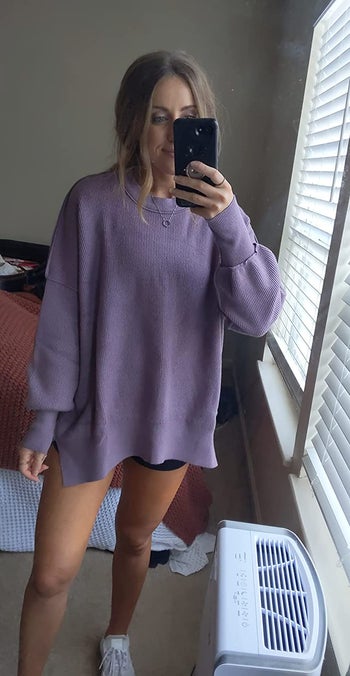 reviewer wearing the sweater in purple