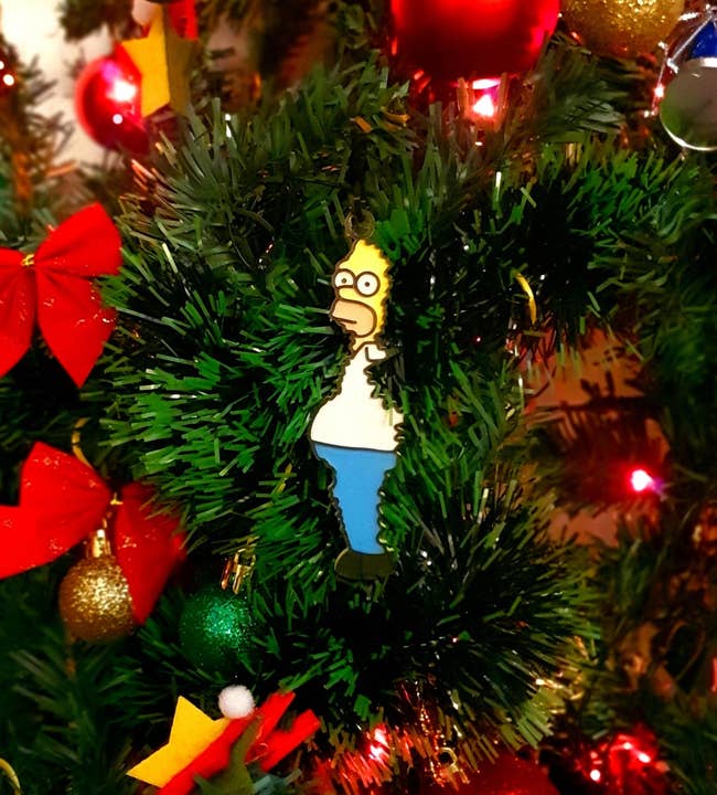 ornament that looks like homer simpson coming out of the tree like the meme of him in the bushes