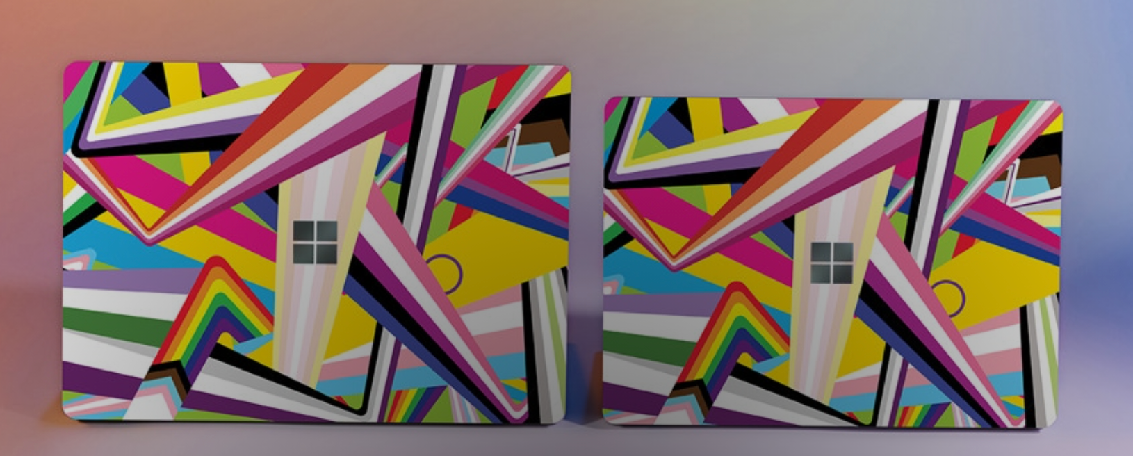 the two sized microsoft laptops with colorful designs on them