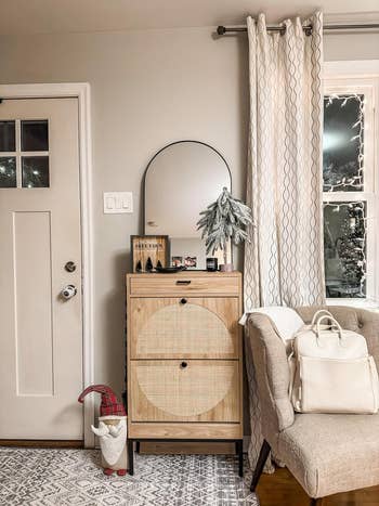 A country   entryway with a closed footwear  cabinet
