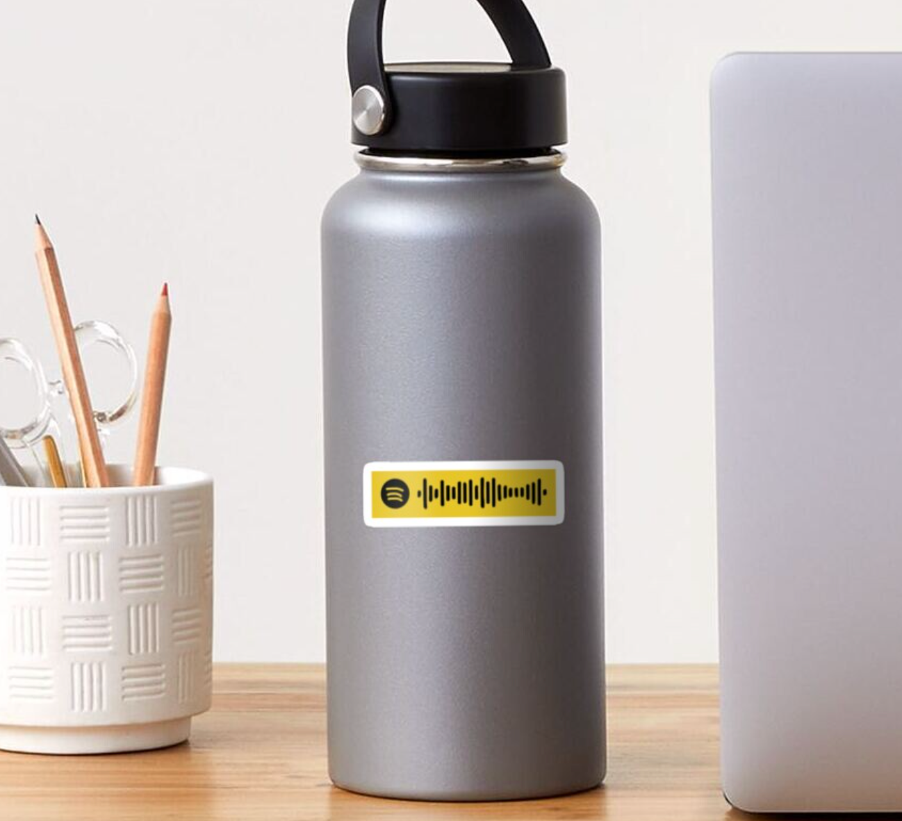 yellow spotify code sticker on a water bottle 