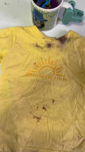 A stained yellowish  babe  T-shirt with 