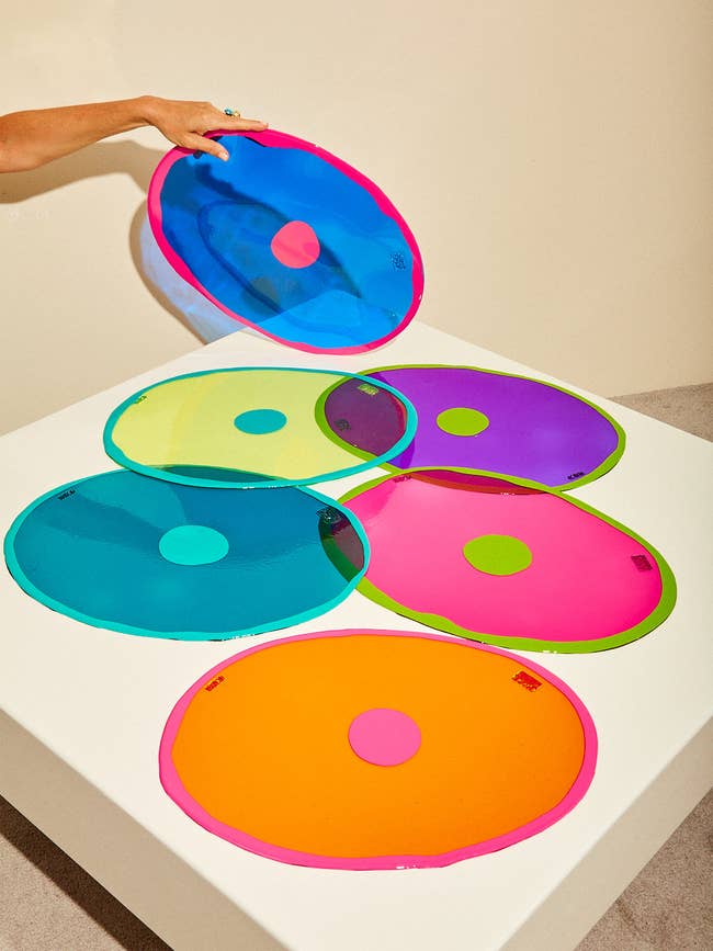 several colorful placemats with a dot in the middle