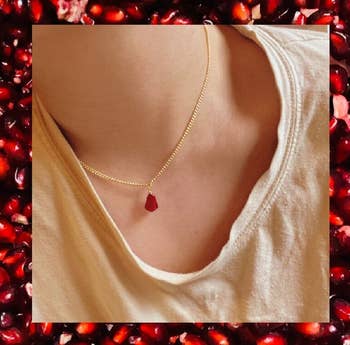Someone wearing the pomegranate necklace