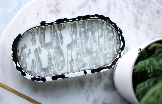 oval-shaped catchall dish in black and white splash