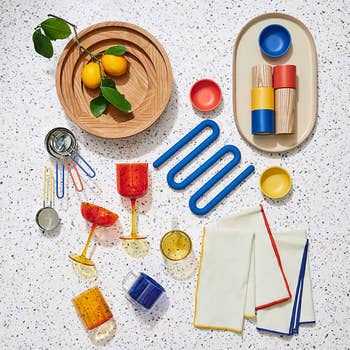 an array of molly baz cooking utensils in primary colors