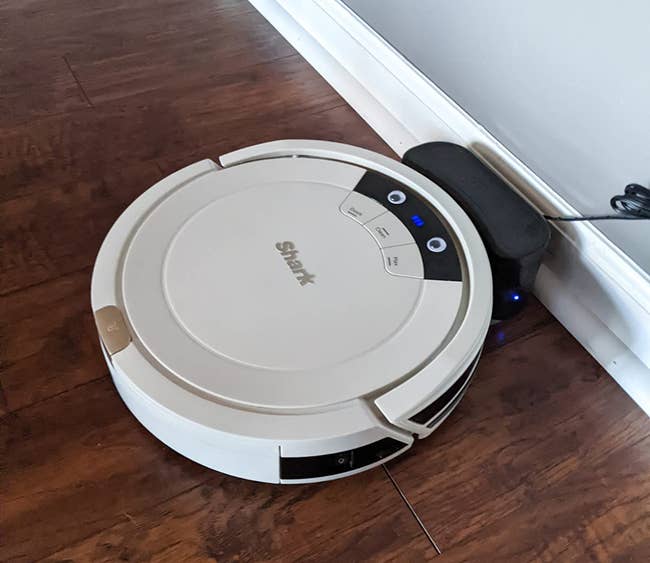 reviewer image of the round robot vacuum in white