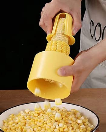 Model peeling corn into a bowl 