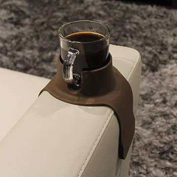 a mug of coffee in the couchcoaster on a sofa