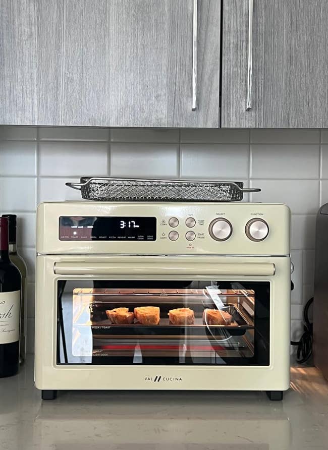 White rectangular air fryer with a clear window displaying toasting bread on the inside 
