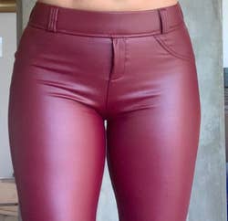Close up of reviewer wearing product in wine red with belt loops and sewed in pockets