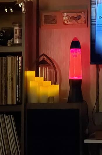 the candles next to a lava lamp in a living room